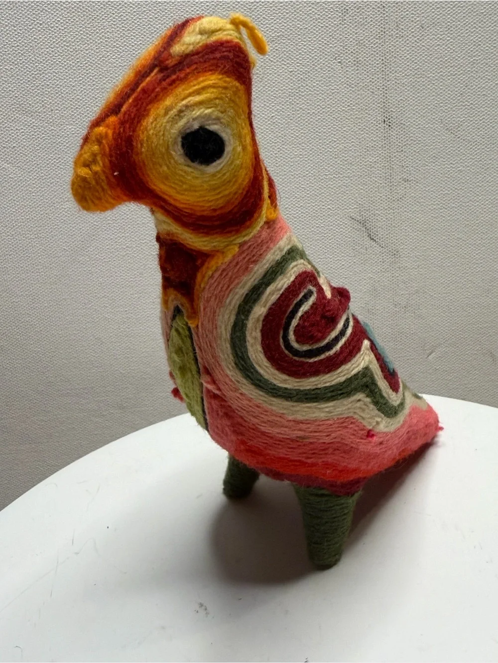 traditional bird figurine in the Huichol yarn art style